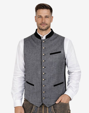 Front view of model wearing Premium Trachten Vest for Men in grey fabric with black trim pockets and metal buttons