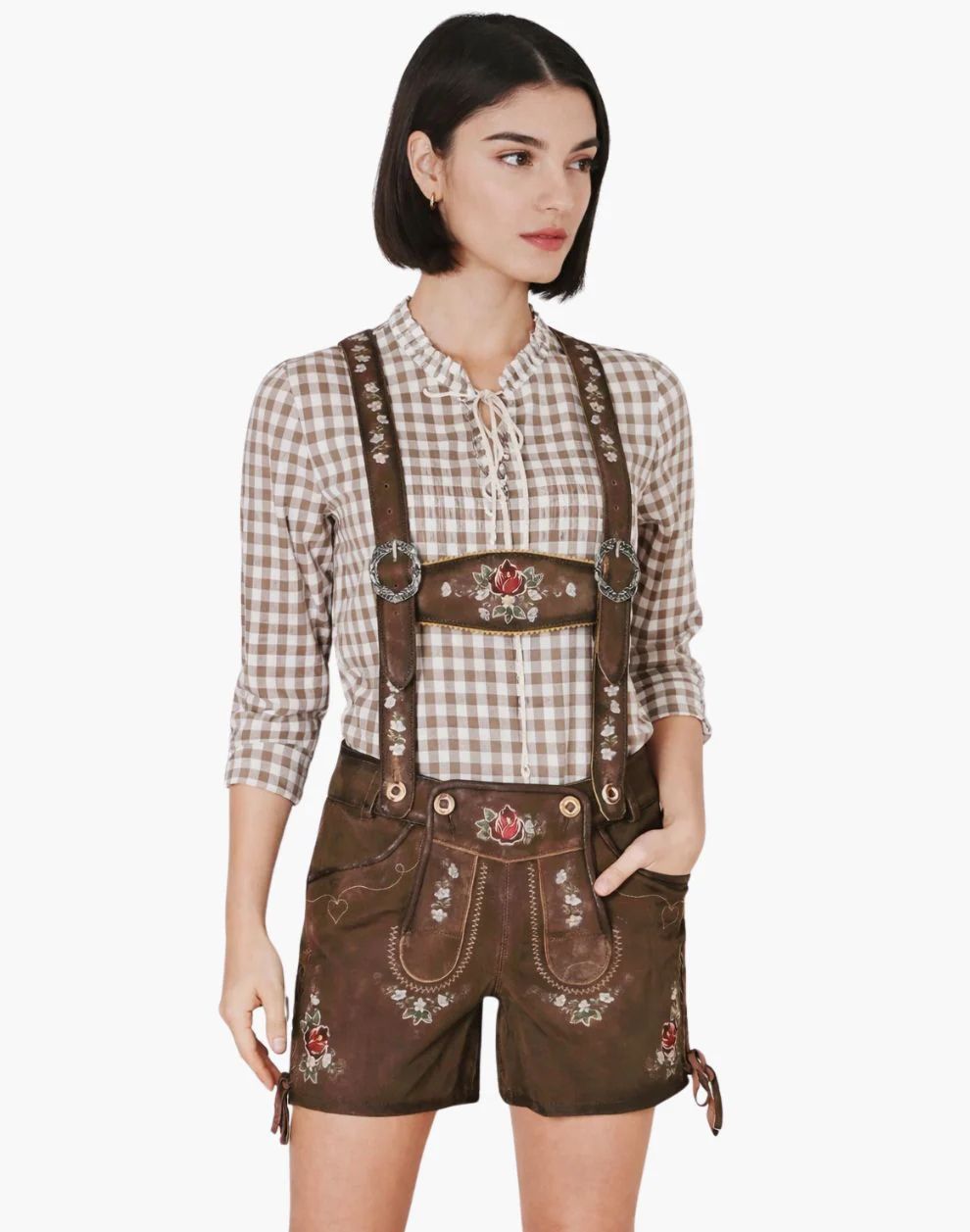 Woman wearing a traditional Bavarian outfit with a checkered shirt and brown shorts on a white background