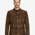 Model wearing rustic brown suede Trachten jacket with classic Bavarian style, stand collar, front buttons, and authentic Oktoberfest look.