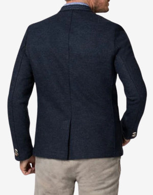 Back view of rustic dark blue German heritage jacket for men with clean tailored structure, classic Bavarian styling, and premium wool fabric.