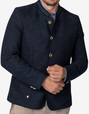 Close-up of rustic dark blue German heritage jacket showcasing textured wool fabric, decorative buttons, stand collar, and traditional Bavarian craftsmanship details.