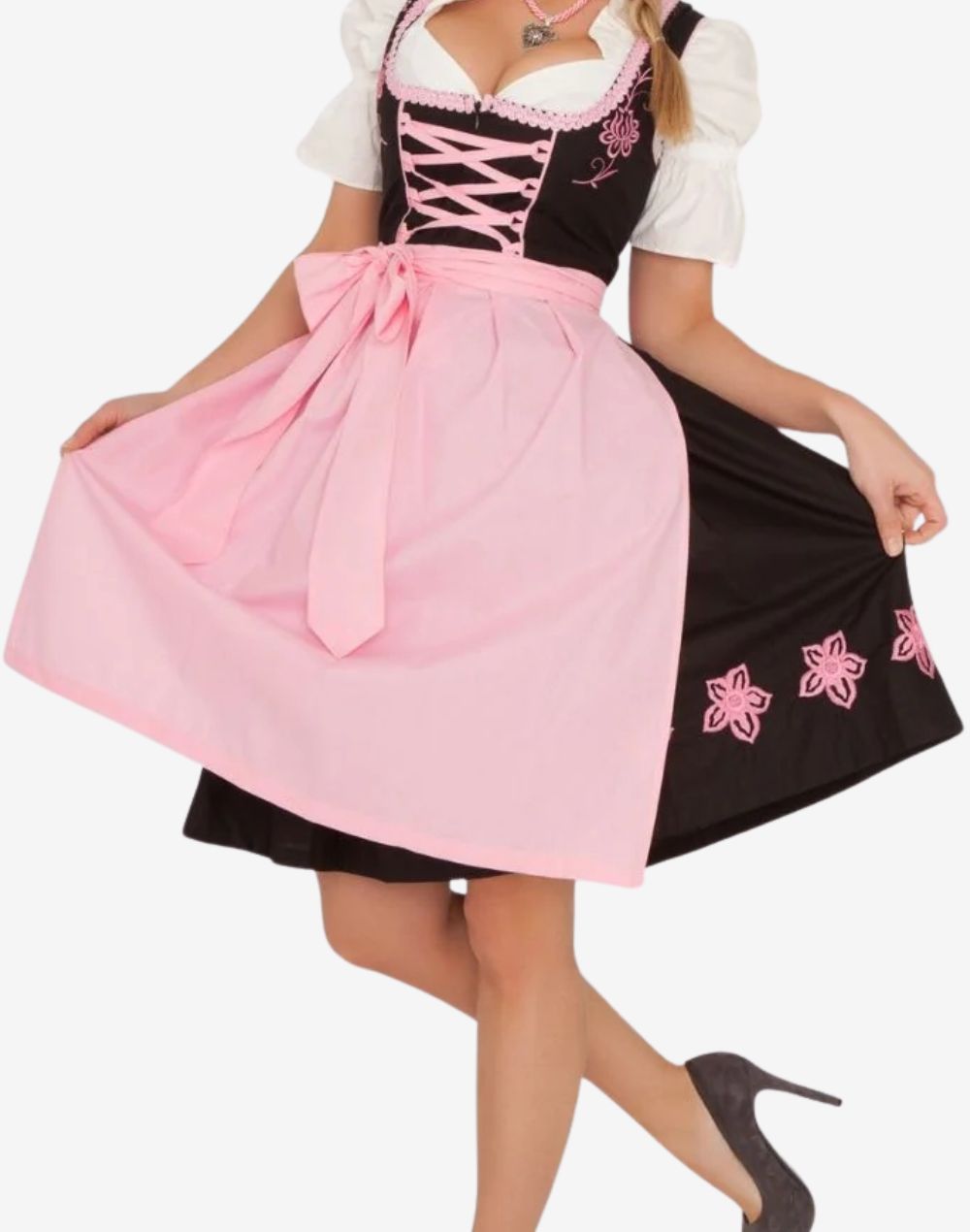 Angled view of model wearing rustic German dirndl dress highlighting apron flow, embroidered skirt detail and feminine fit