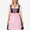 Front view of model wearing rustic German dirndl dress showing pink apron, black bodice, lace trim and traditional Oktoberfest fit