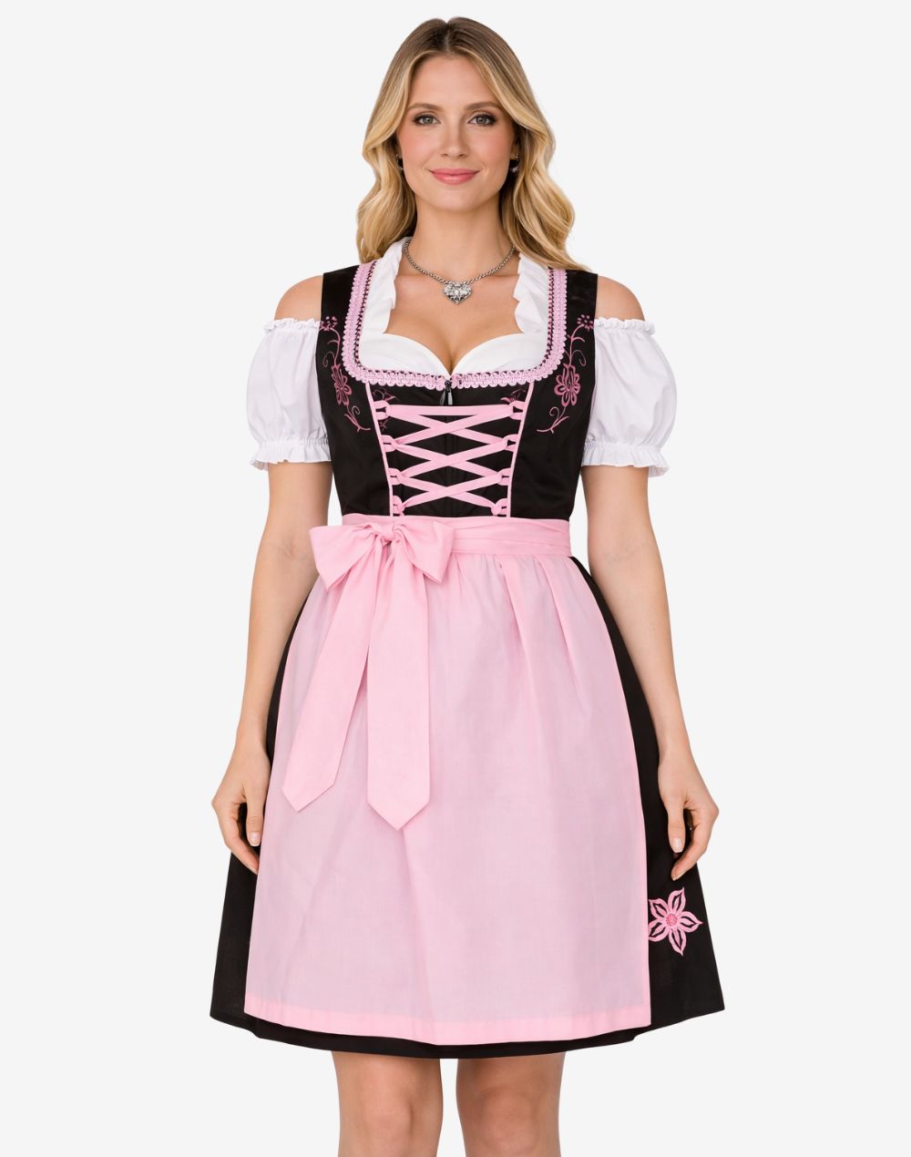 Front view of model wearing rustic German dirndl dress showing pink apron, black bodice, lace trim and traditional Oktoberfest fit