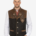 Model wearing rustic German Trachten vest with leather details, wool body and traditional Bavarian Oktoberfest styling.