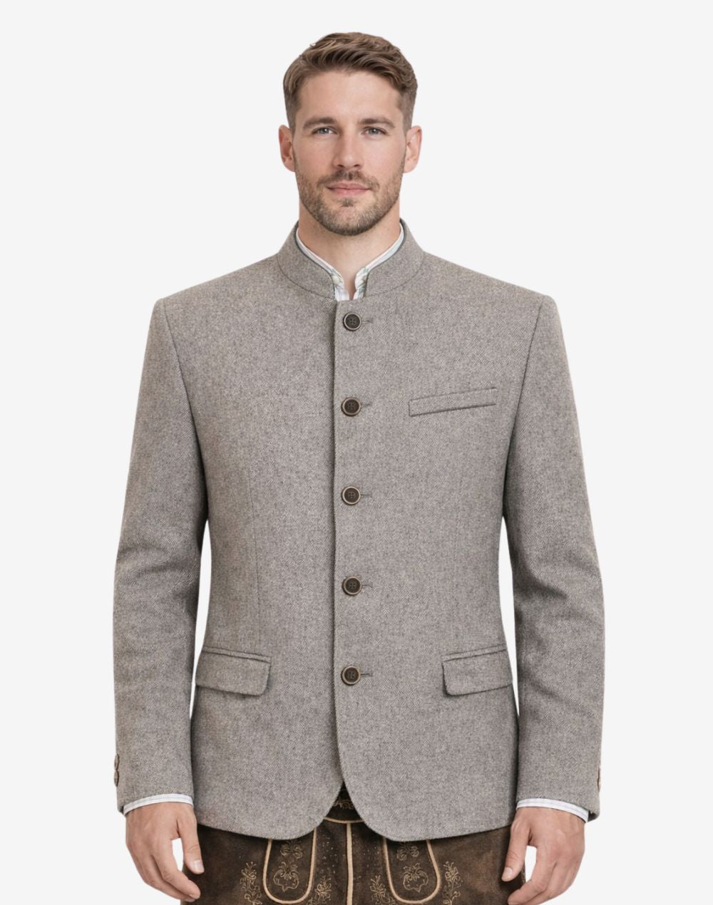 Model wearing rustic grey Bavarian jacket for men with traditional Trachten styling, stand collar, button front closure, tailored fit, and classic Oktoberfest outfit paired with lederhosen.