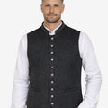 Male model wearing rustic wool Bavarian vest paired with traditional lederhosen, ideal for Oktoberfest and Alpine events.