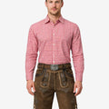 Model wearing rustic mens traditional lederhosen in brown leather with Bavarian embroidery and classic Oktoberfest belt buckle