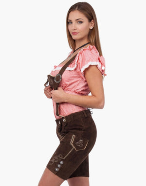 Woman wearing a traditional Bavarian outfit with a pink blouse and brown shorts on a white background