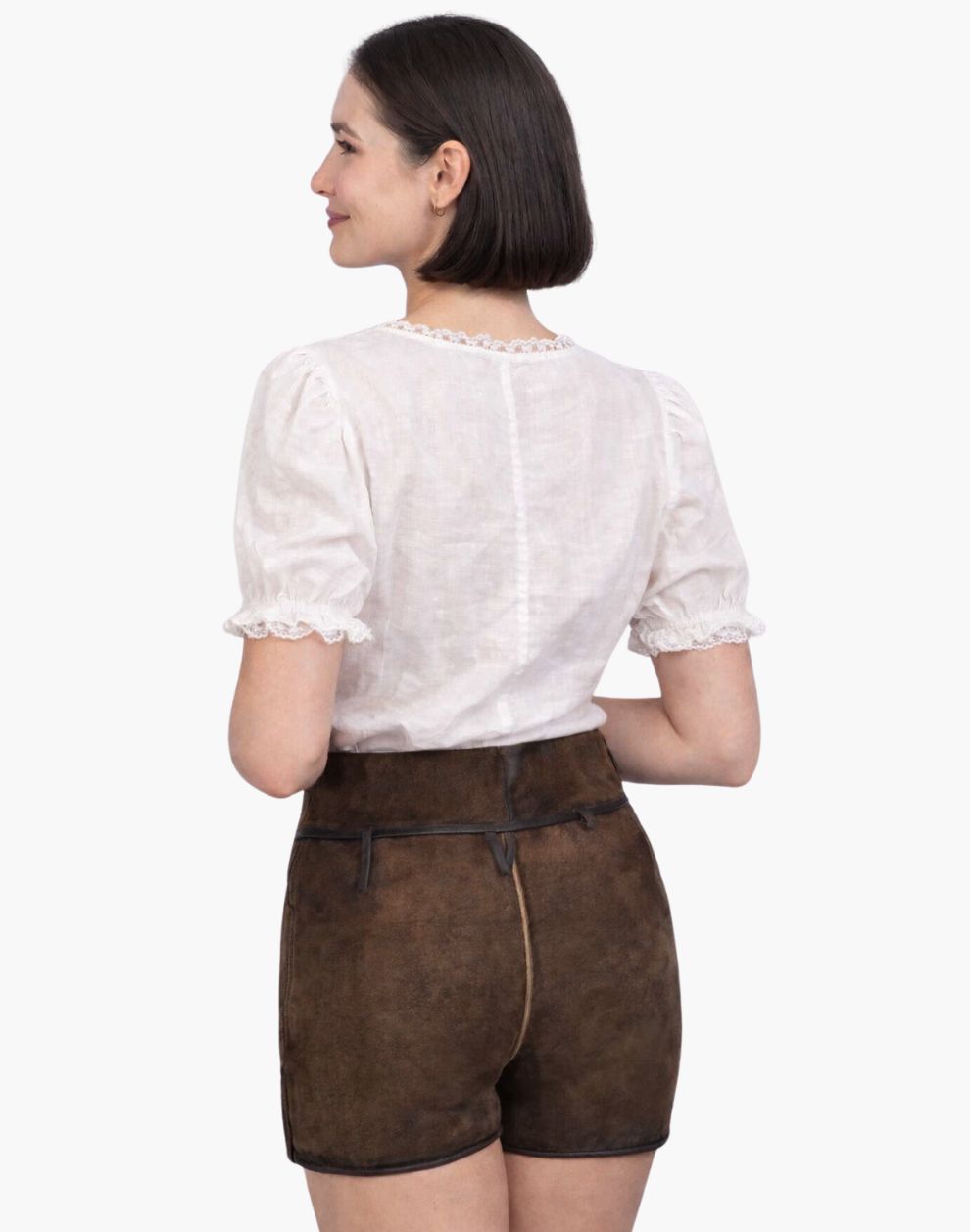 Woman wearing a white blouse and brown shorts on a white background