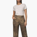 Woman wearing a white t-shirt and brown pants on a white background