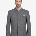 Model wearing traditional alpine jacket for men front view featuring gray wool fabric, horn style buttons and classic Bavarian design.