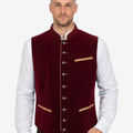 Model wearing traditional Alpine vest for men paired with shirt and lederhosen for authentic Bavarian Oktoberfest outfit.