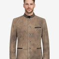Front view of model wearing Traditional Bavarian Leather Jacket Men in rustic tan with embroidered collar and metal buttons