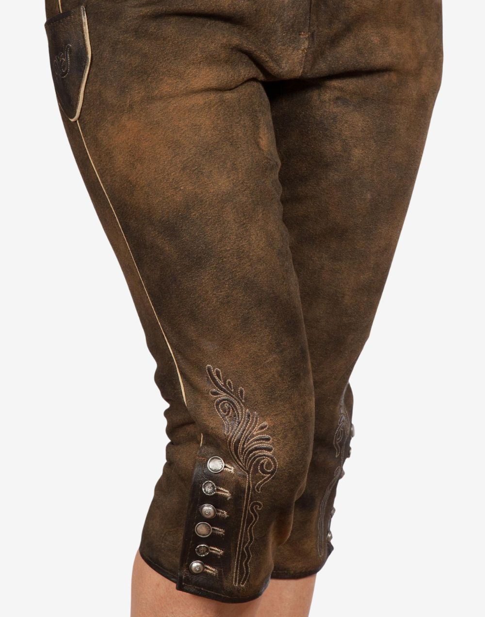 Close-up of women’s brown leather bundhosen showing embroidered knee detailing, decorative metal buttons, and traditional Bavarian alpine design with a vintage finish.