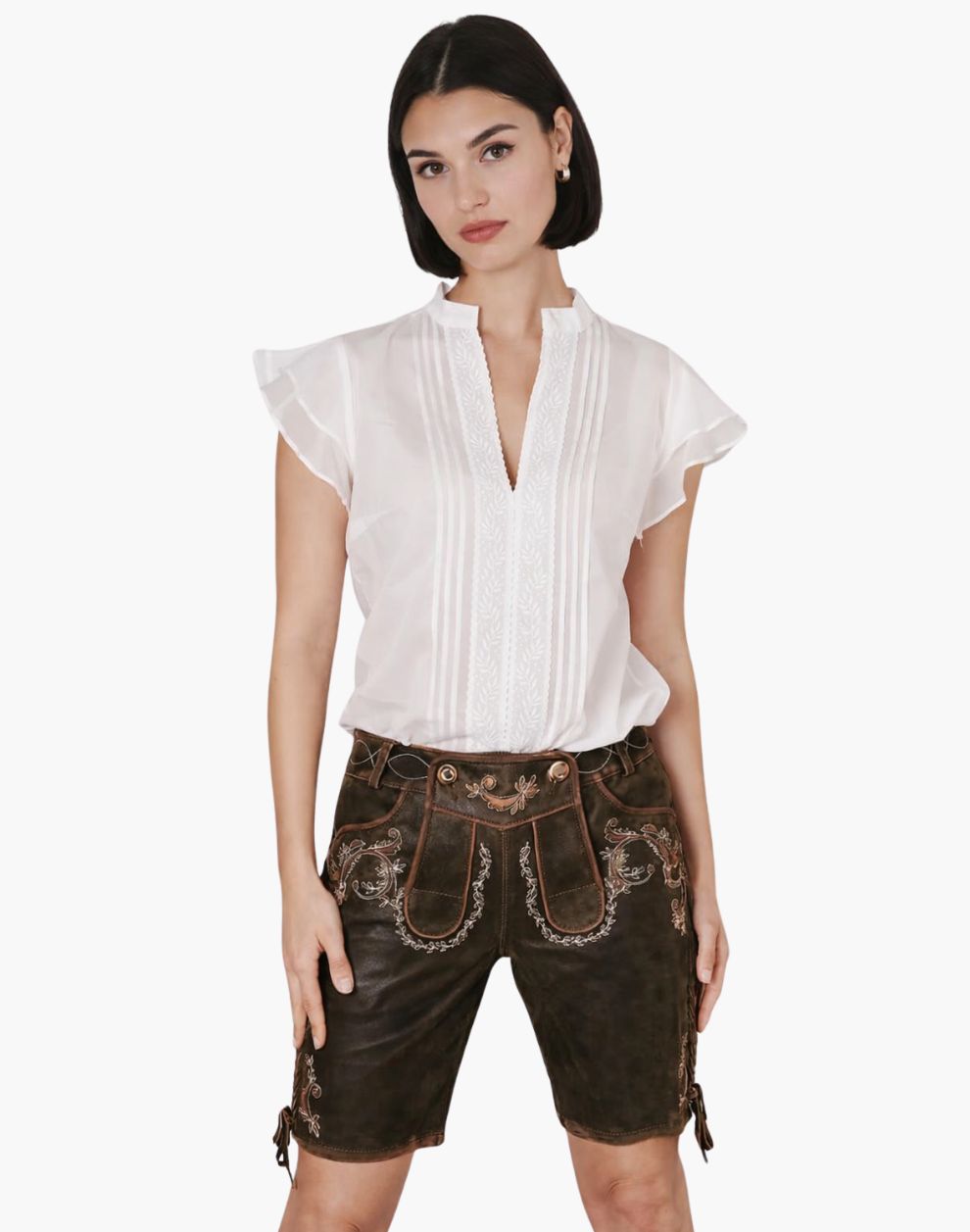 Woman wearing a white blouse and brown traditional shorts on a white background