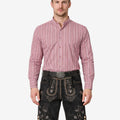 Model wearing traditional German lederhosen for men in brown leather with Bavarian embroidery and classic suspenders