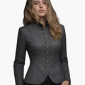 Woman wearing a gray blazer with buttons on a white background