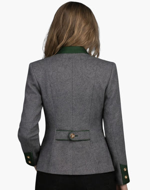Rear view of a woman wearing a grey Oktoberfest Trachten jacket with green accents, structured tailoring, and traditional alpine styling.