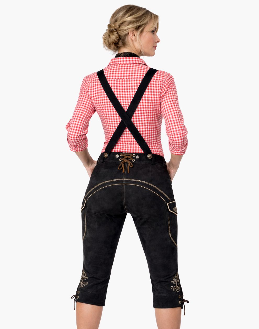 Woman wearing a traditional Bavarian outfit with black pants and red checkered shirt on a white background
