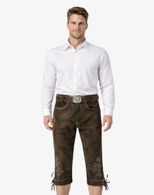 Man wearing a white shirt and brown pants with embroidery on a white background