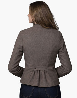 Back view of a woman wearing a vintage-inspired brown Trachten blazer with a pleated back detail and tailored fit, paired with dark jeans, against a white background.