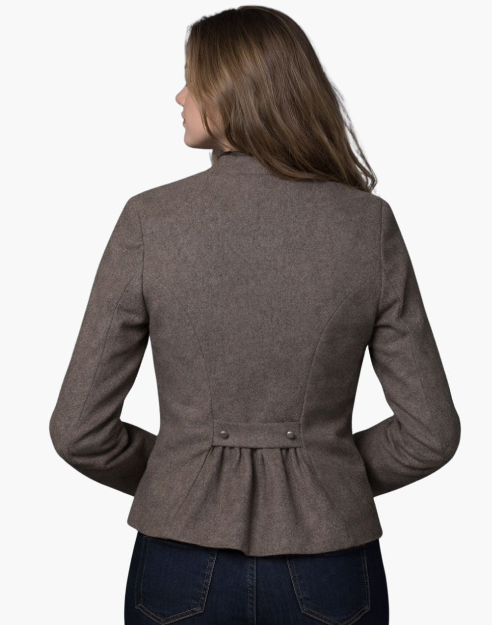 Back view of a woman wearing a vintage-inspired brown Trachten blazer with a pleated back detail and tailored fit, paired with dark jeans, against a white background.