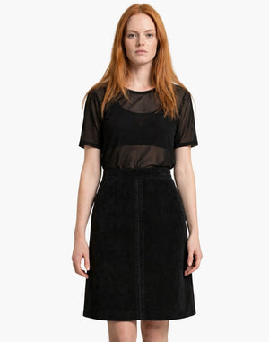 Woman wearing a black dress with sheer panels on a white background