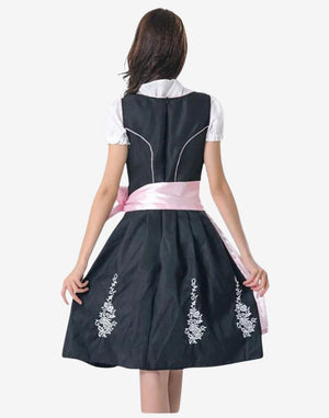 Back view of women Bavarian festival dirndl dress worn by model highlighting black skirt, embroidered detail and fit