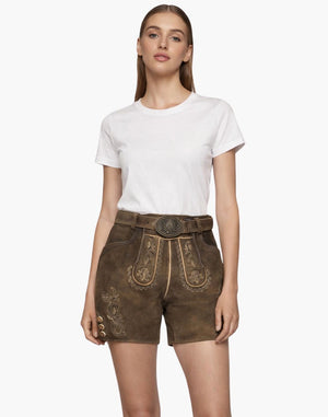 Woman wearing a white t-shirt and brown embroidered Lederhosenson a white background