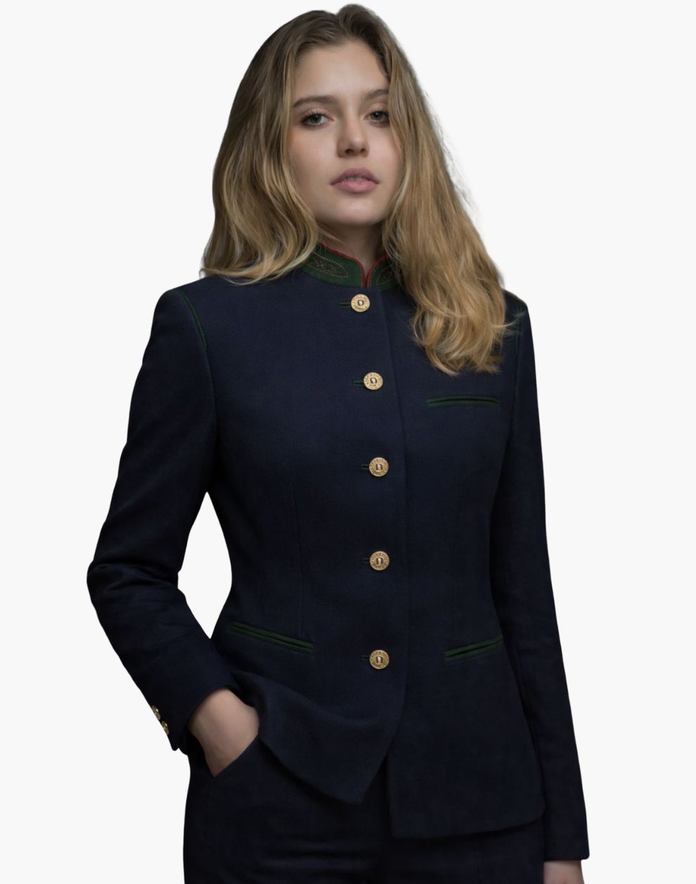 Front view of a woman wearing a deep navy tailored jacket with a stand-up collar accented in green and red trim. The jacket has a vertical row of gold-tone buttons, green-trimmed welt pockets, and a fitted silhouette, styled with dark trousers. The background is plain light gray.
