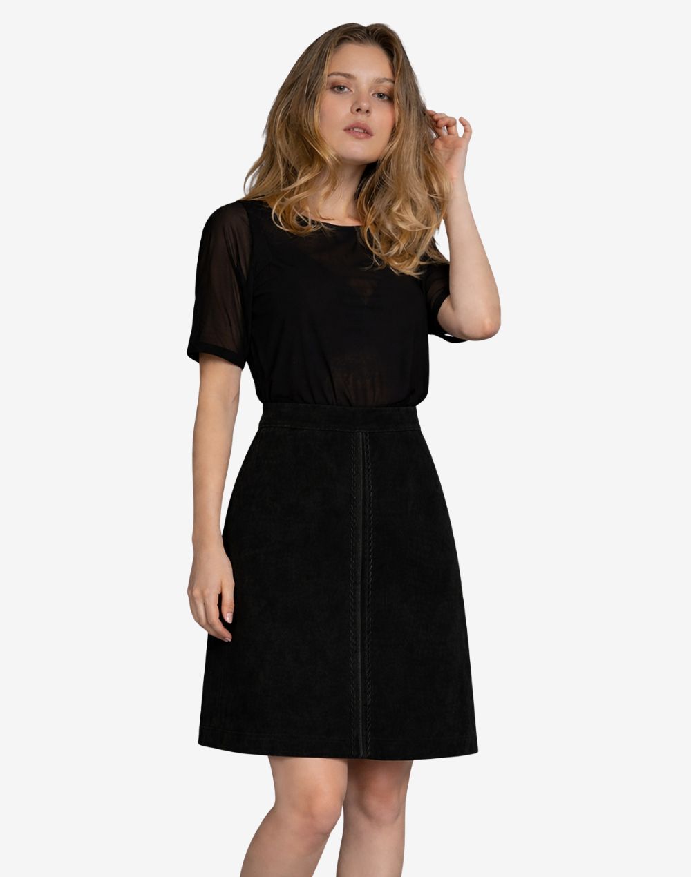 Front view of women's black traditional Trachten skirt paired with a sheer short-sleeve black top, featuring a high-waisted A-line silhouette and subtle front seam detailing.