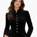 Woman wearing a black velvet Bavarian Trachten jacket with decorative buttons, fitted silhouette, and traditional German design, against a white background.