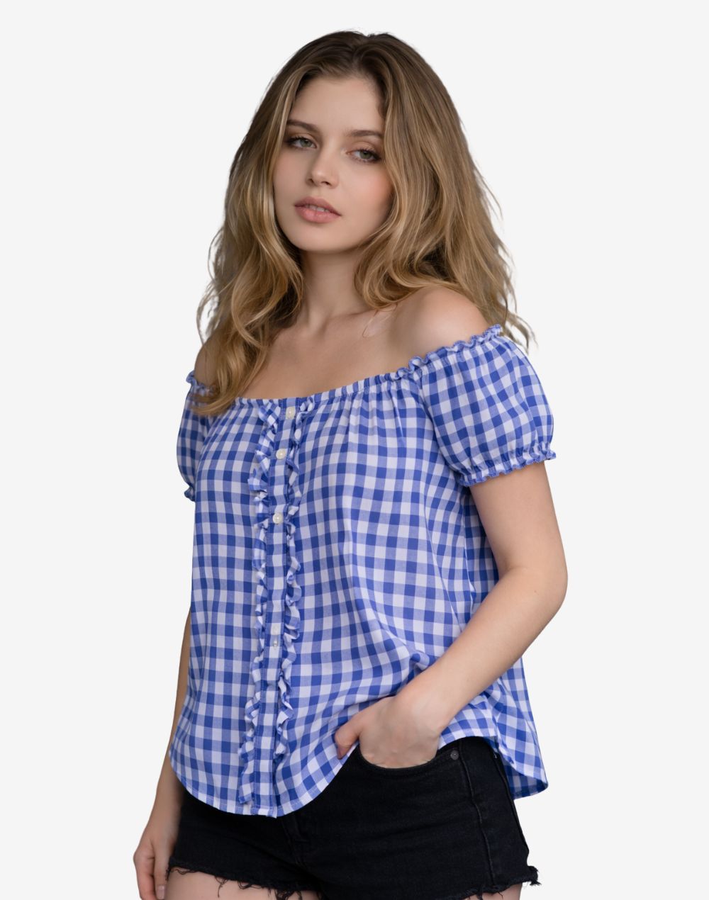 Angled front view of a woman wearing a blue and white gingham off-shoulder dirndl blouse with short puff sleeves, ruffled button placket, and relaxed fit, paired with black denim shorts.