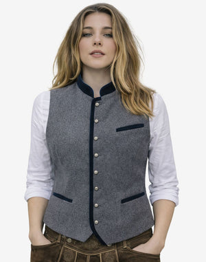 Woman wearing a gray vest with black trim on a white background