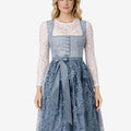 Front view of model wearing womens Oktoberfest dirndl dress featuring blue lace bodice, ribbon waist tie and elegant floral skirt
