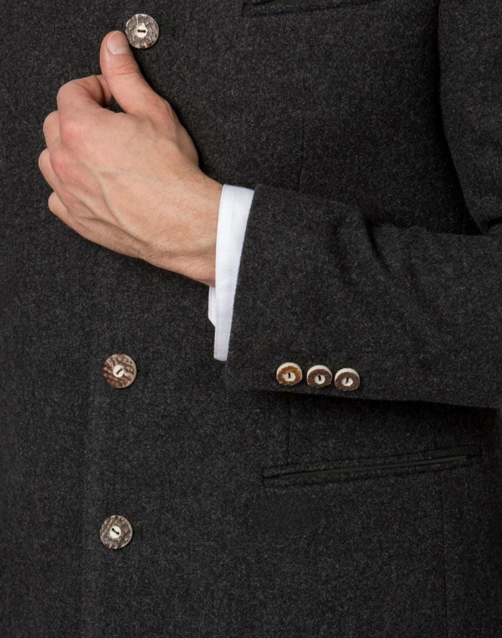 Close up of Trachten jacket sleeve and horn buttons highlighting wool texture, cuff buttons and classic Bavarian craftsmanship.