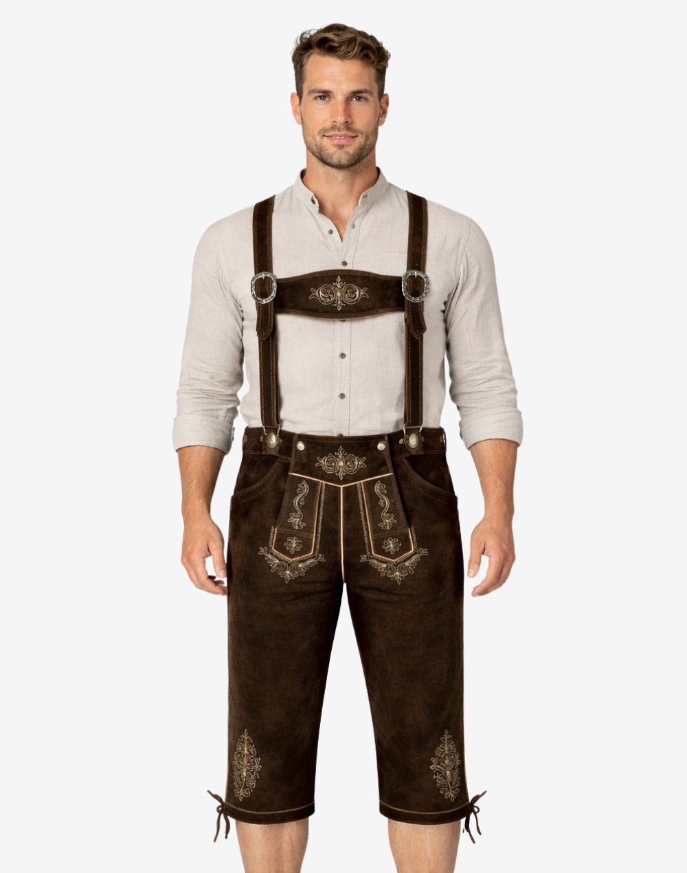 Model wearing dark brown genuine leather Bundhosen with embroidered leather suspenders, floral front flap embroidery, and adjustable lace-up knee openings.