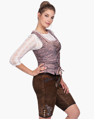 Woman wearing a traditional Bavarian outfit on a white background