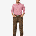 Man wearing a pink checkered shirt and brown cargo pants on a white background