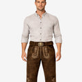 Model wearing men's dark brown leather Bundhosen with engraved antique stag buckle.