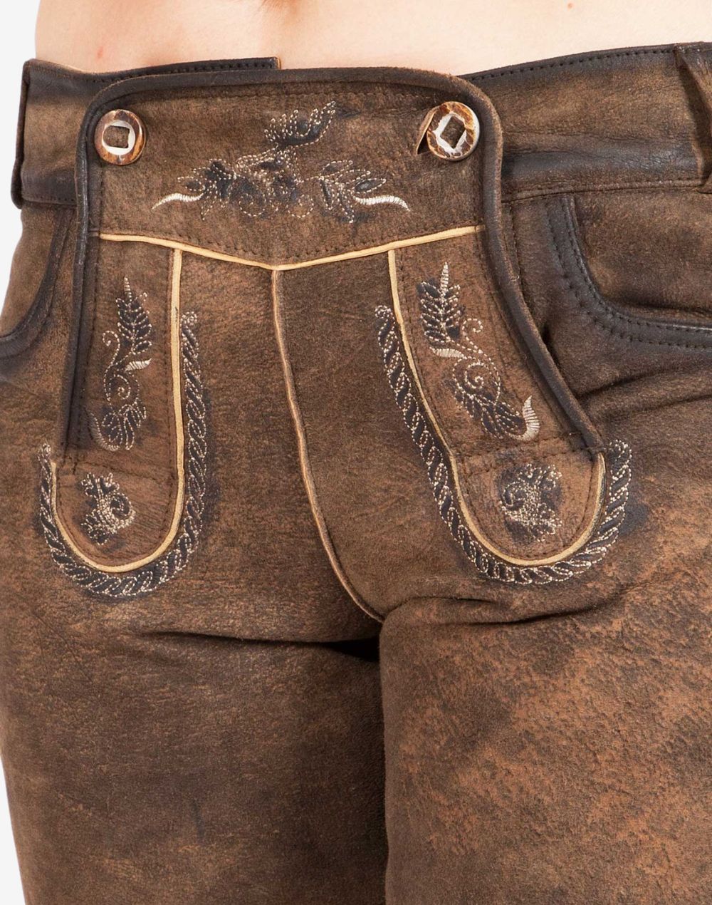 Close-up view of traditional brown leather women’s lederhosen showing decorative front flap with embroidered patterns, metal buttons, and detailed stitching on textured leather.